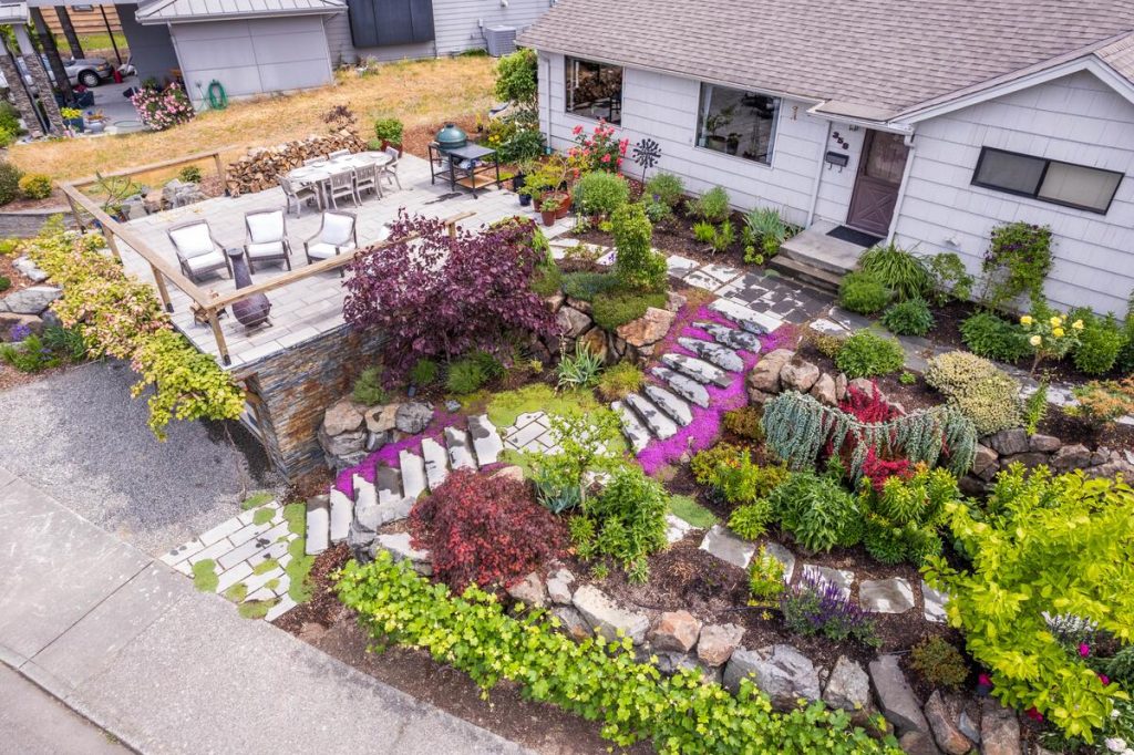 Aerial view of terraced front yard with stone retaining walls and deck in Renton