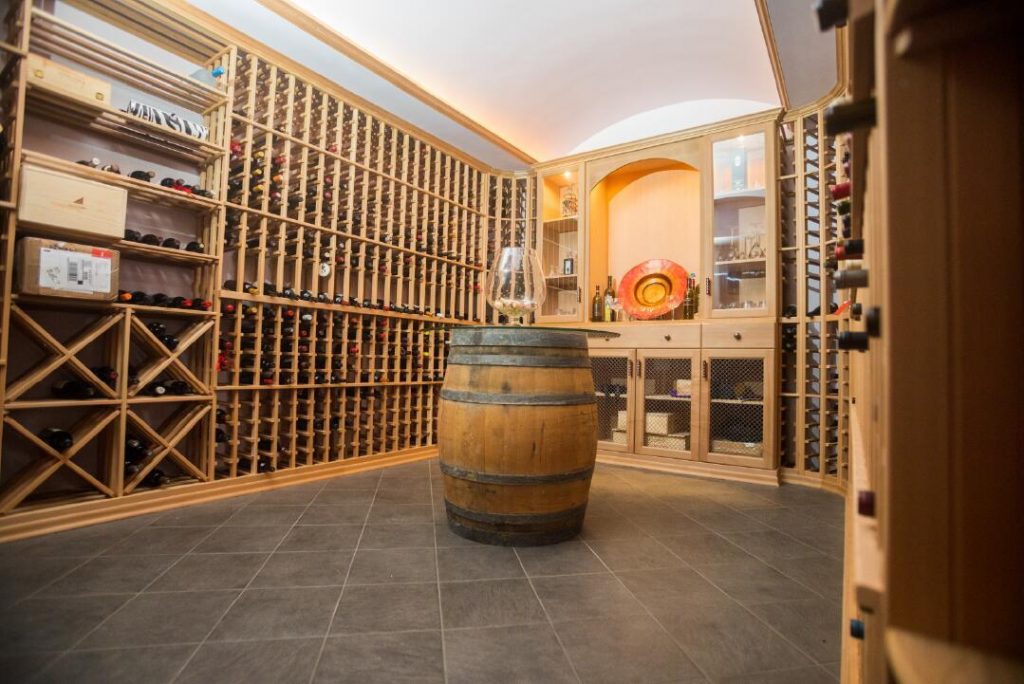 Custom wine cellar with wood storage racking and slate tile floor