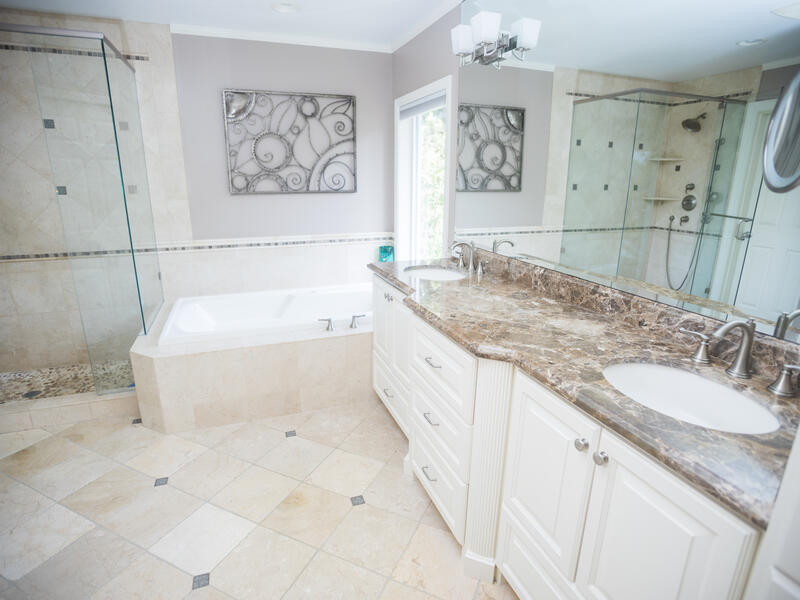 Complete transformation with custom tile work, curbed shower, and modern fixtures.