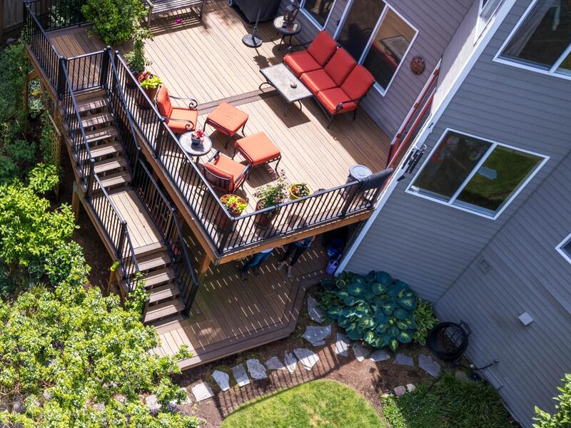 Multi-level composite deck in Newcastle with cable railings and a custom pondless waterfall.