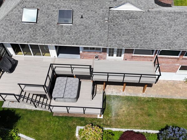 Aerial view of composite deck with hot tub and cable railings