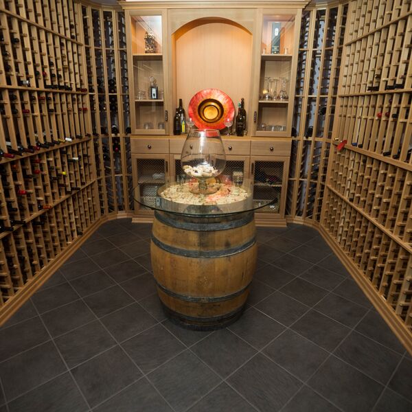 Custom wine cellar with wood racking and barrel table
